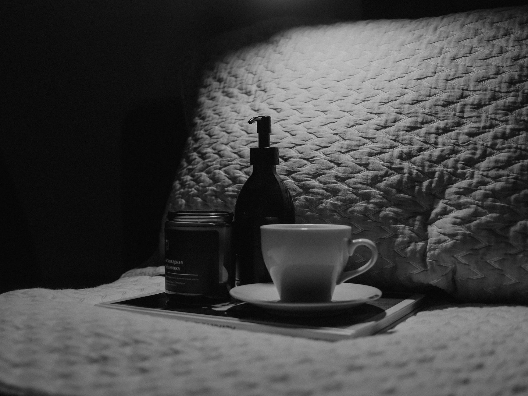 Pot de crème de nuit sur table de chevet avec bougie